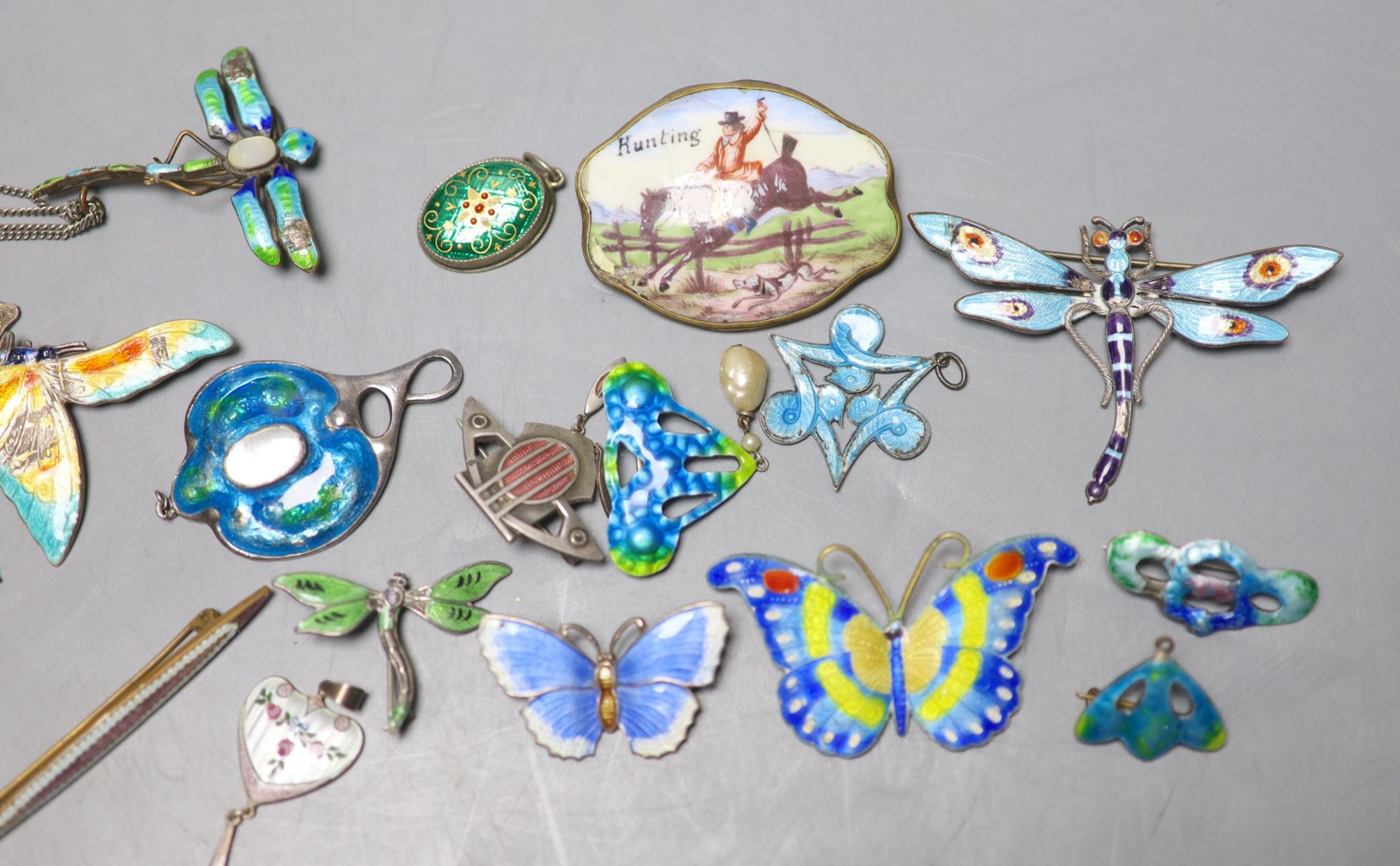 A mixed group of enamelled jewellery.